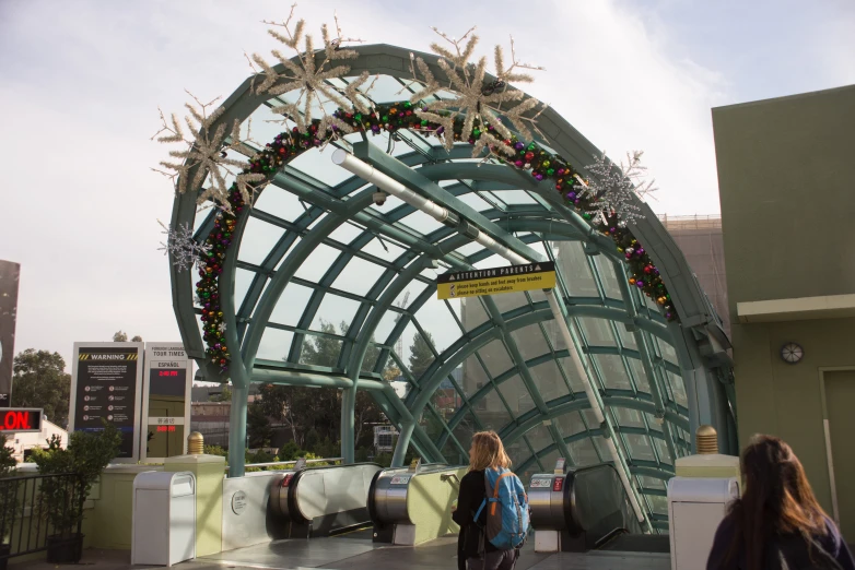 two people looking at a very unique arch made from metal and wood