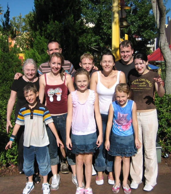 a family poses for a po while posing in front of a stop sign