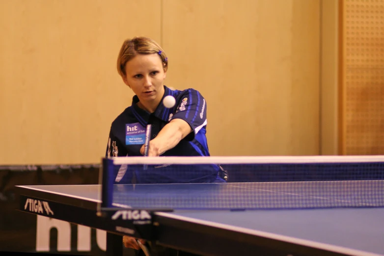 a person standing at a table with a tennis racket