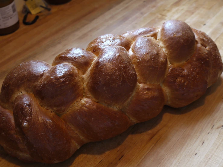 a fresh baked bread sitting on top of a wooden table