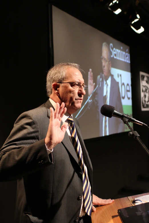 a man giving a speech at a podium