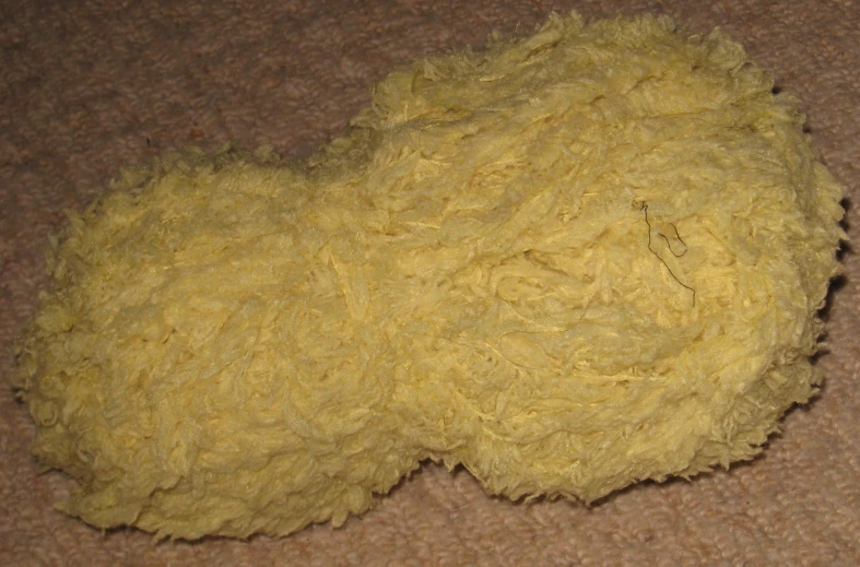 a pile of fluffy yellow stuff on the floor