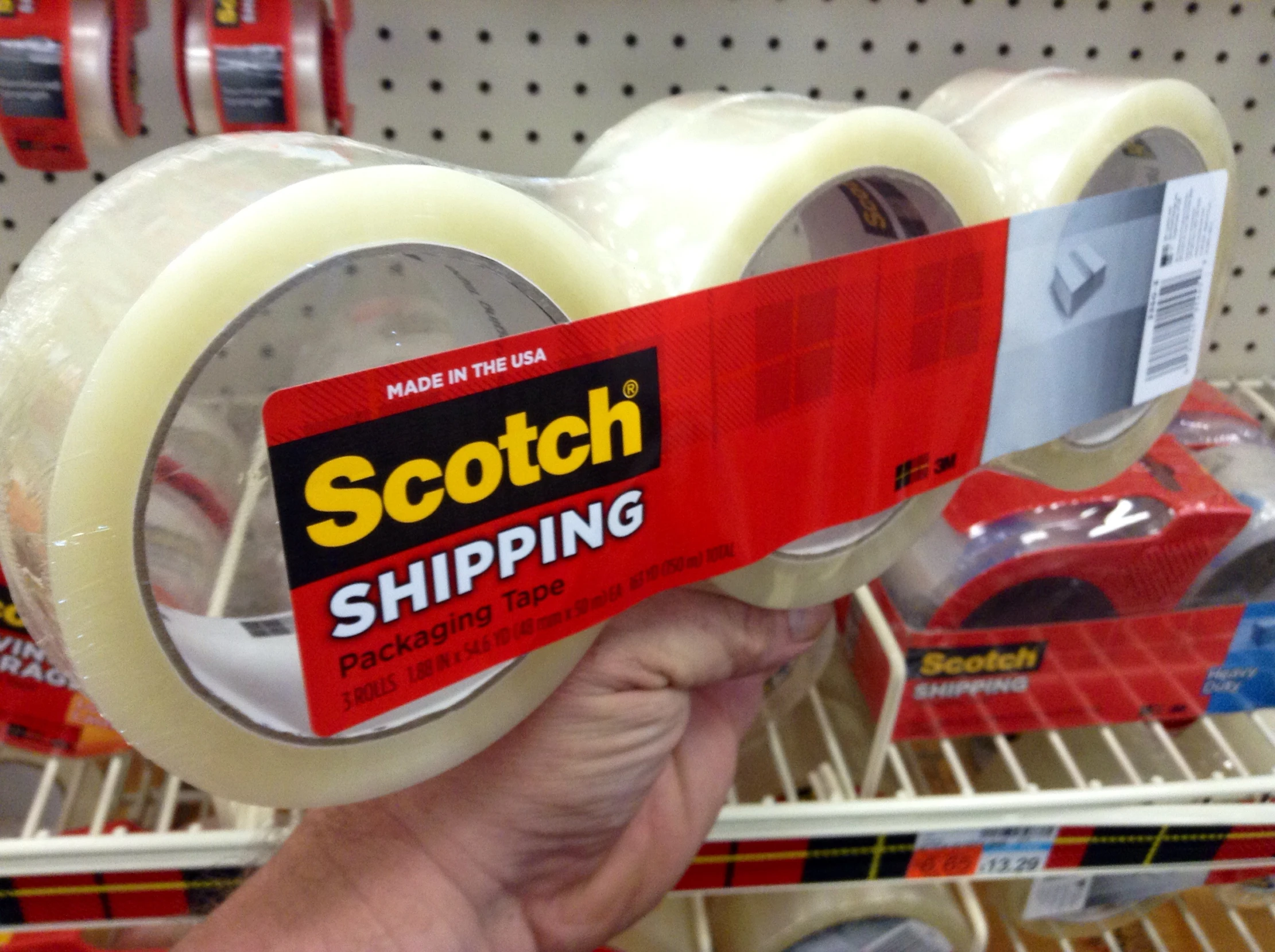 a person holding a white scotch tape in their left hand