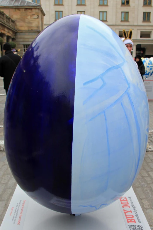 a blue and white sphere on top of a white pedestal