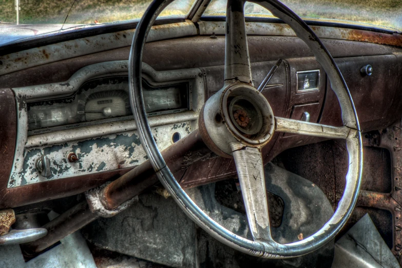 the dashboard of an abandoned, run down car