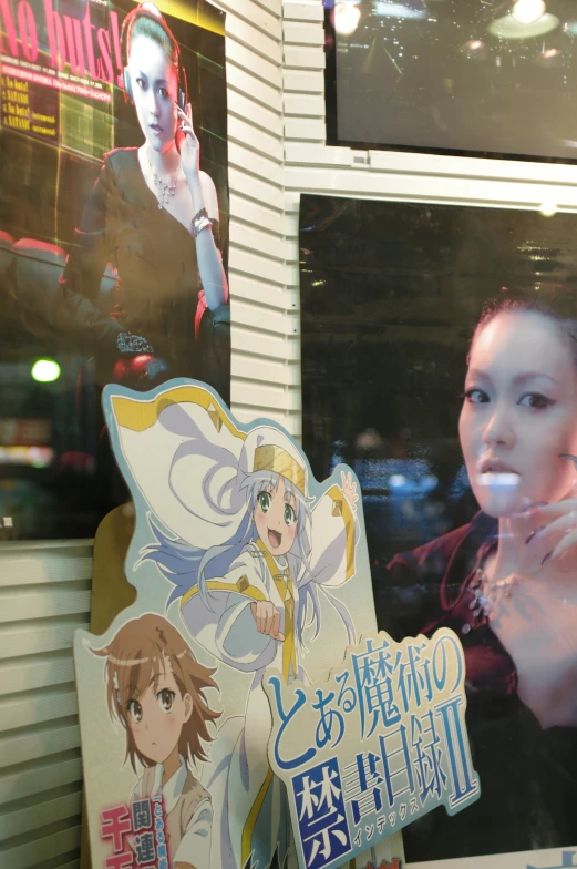 two anime poster displayed with a woman smoking