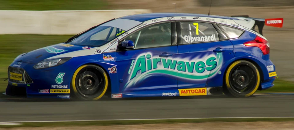 a blue car on track with airwaves on the side