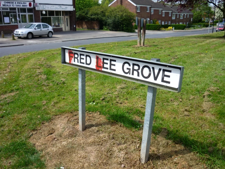 a sign that says red eeve grove sitting in the grass