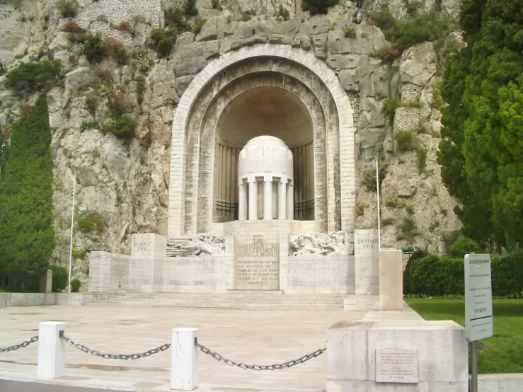 an elaborate monument is situated near a wall