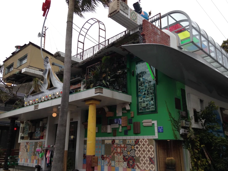 the house is green and has some stairs on it