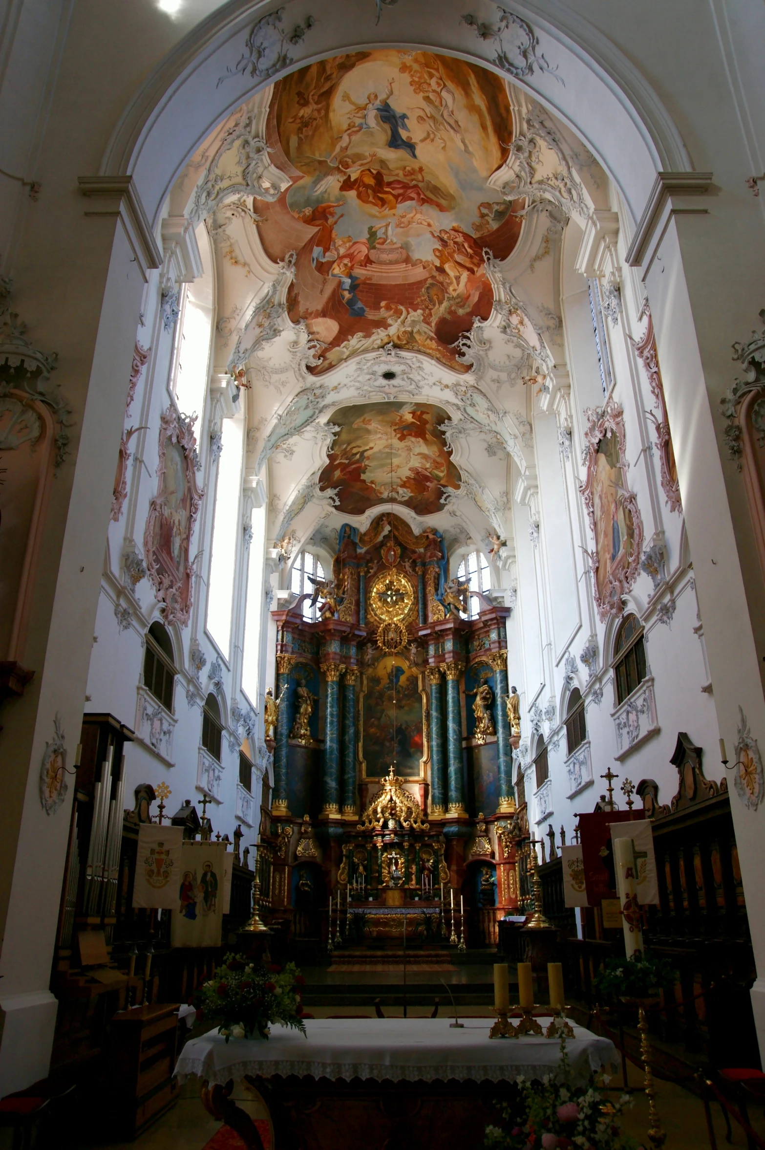 the interior of a church with large paintings on the walls