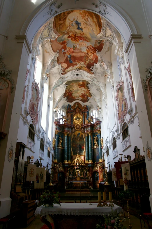 the interior of a church with large paintings on the walls