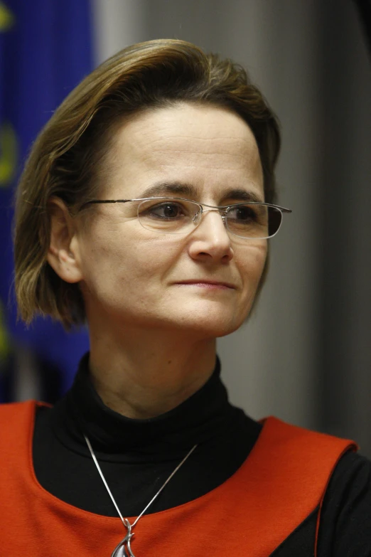 an older woman wearing glasses is smiling for the camera