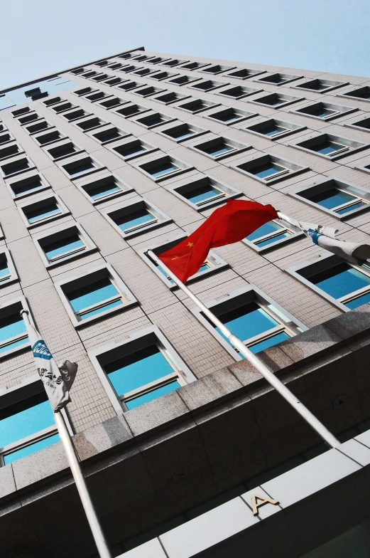 a flag flies from the top of an apartment building