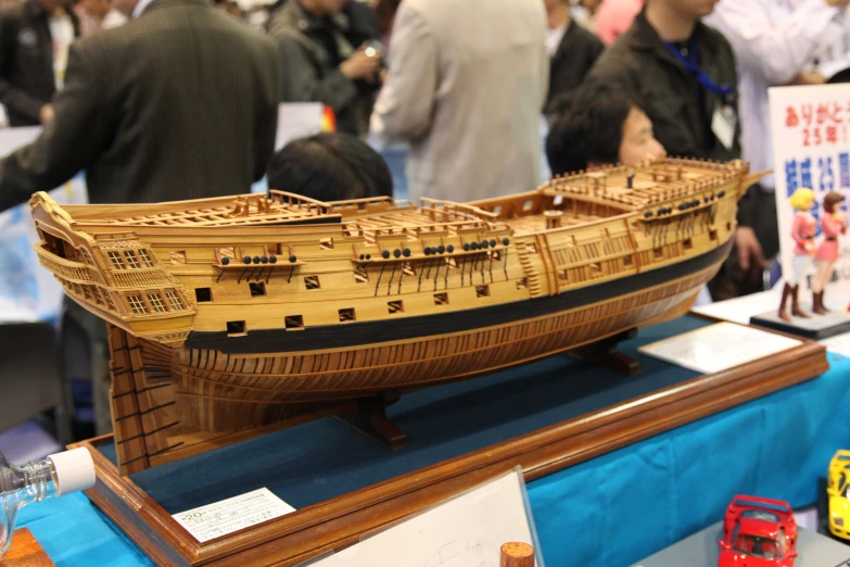 a model ship is being displayed at an expo