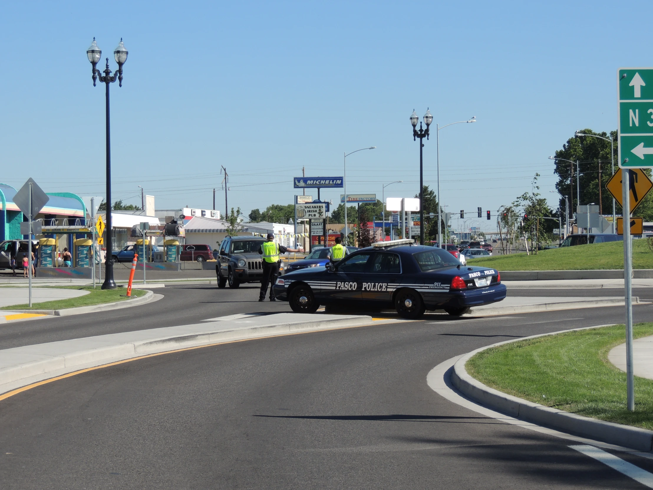 there are two police officers directing traffic at a stop sign