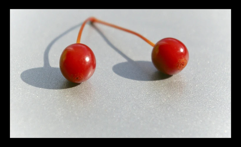 two cherry fruits sit together on the table