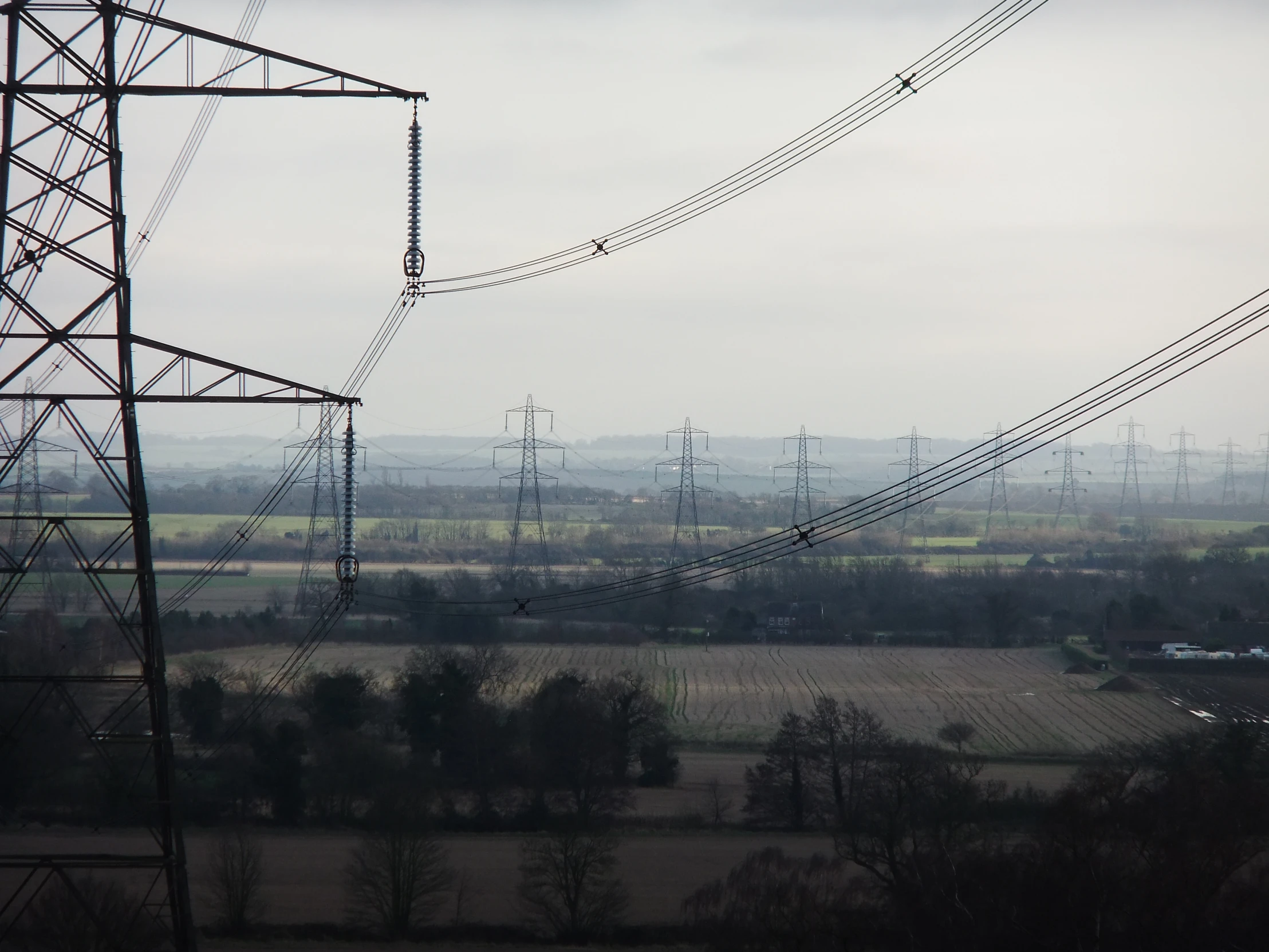the view of some power lines next to fields
