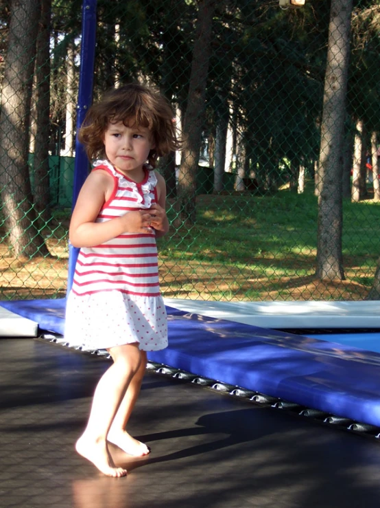 a  is standing on a trampoline at a park