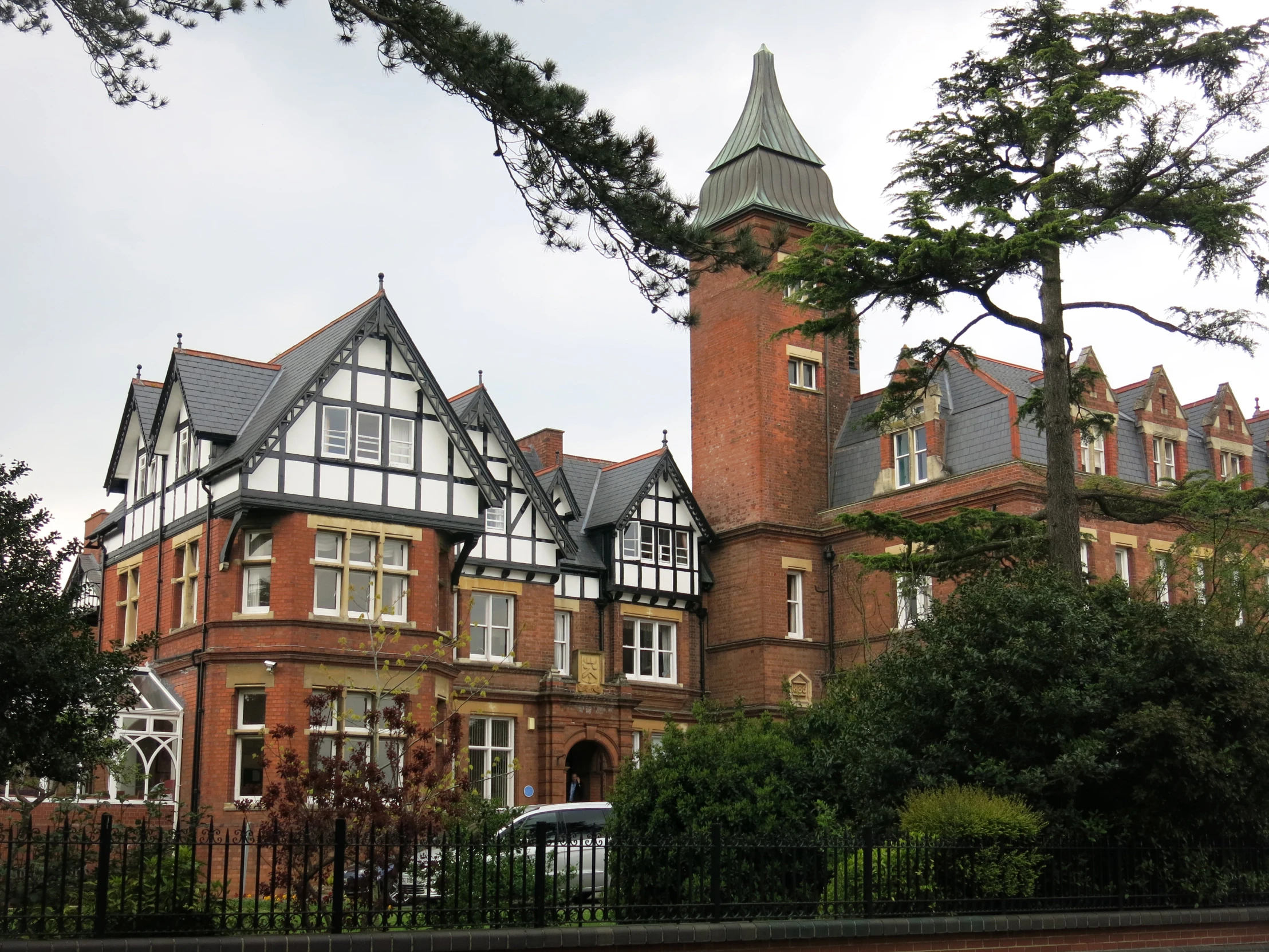 the large brick building with tall windows is made of stone