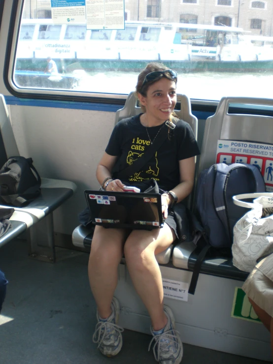 the woman sits in a train looking out the window