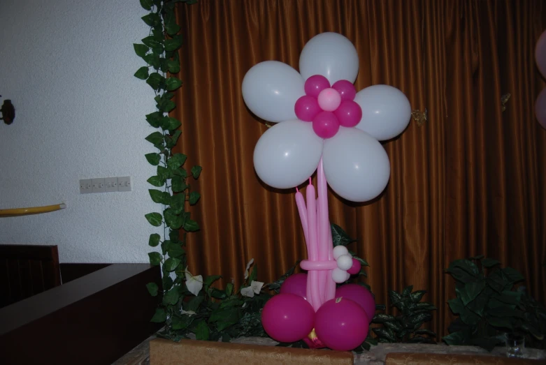 a balloon with a flower on it near a window