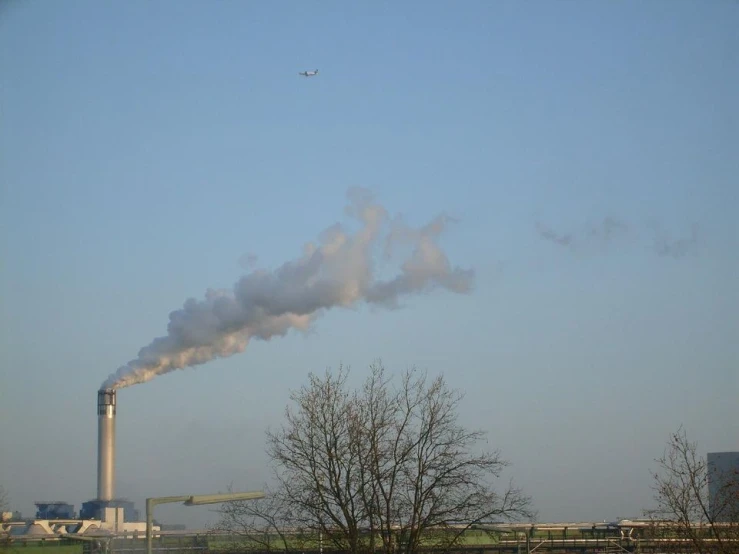 smokestack coming out from the side of an industrial complex