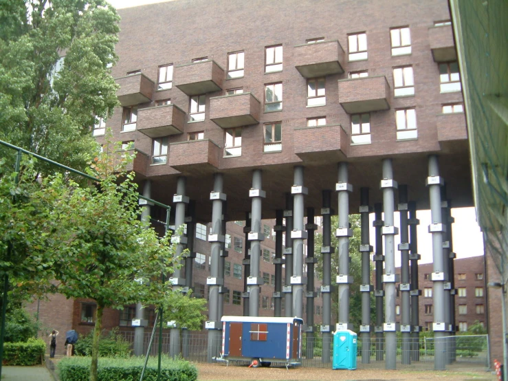 a large building with many windows and a blue bus