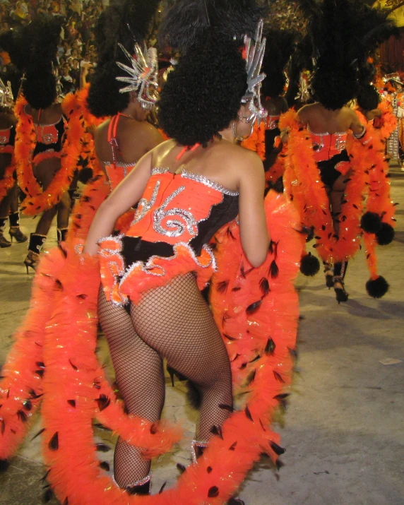 women are dressed up and performing in colorful costumes