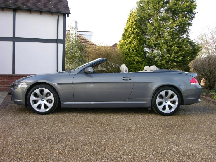 the grey car is parked outside the large building