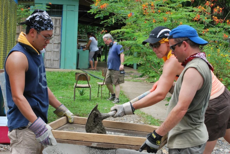 people are constructing a raised walkway that leads to a building