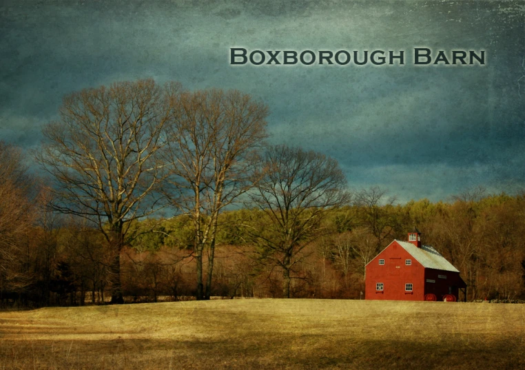 a barn that is red next to some trees