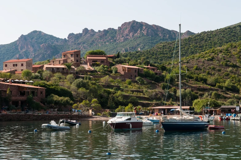 a marina with some boats out on the water and some mountains