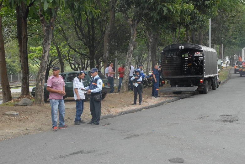 men with cameras are waiting by a truck