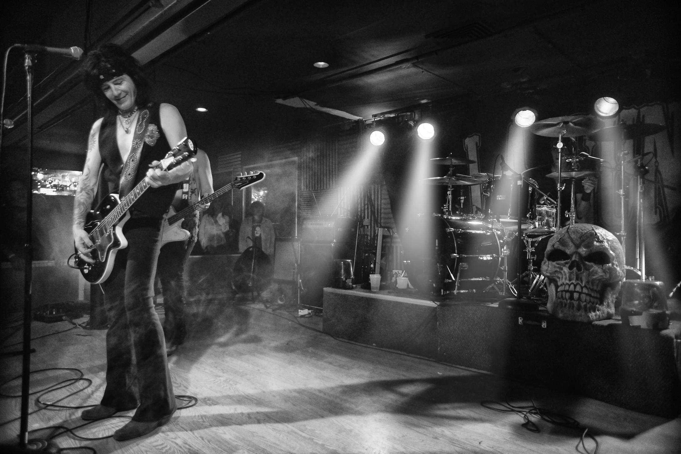 the band playing on stage with their guitars and lights behind them