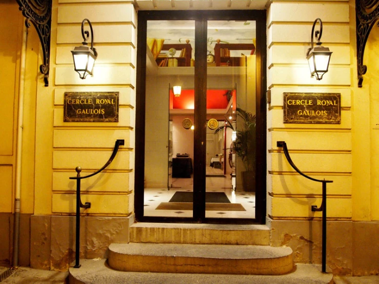 the entrance of a yellow building with signs on it