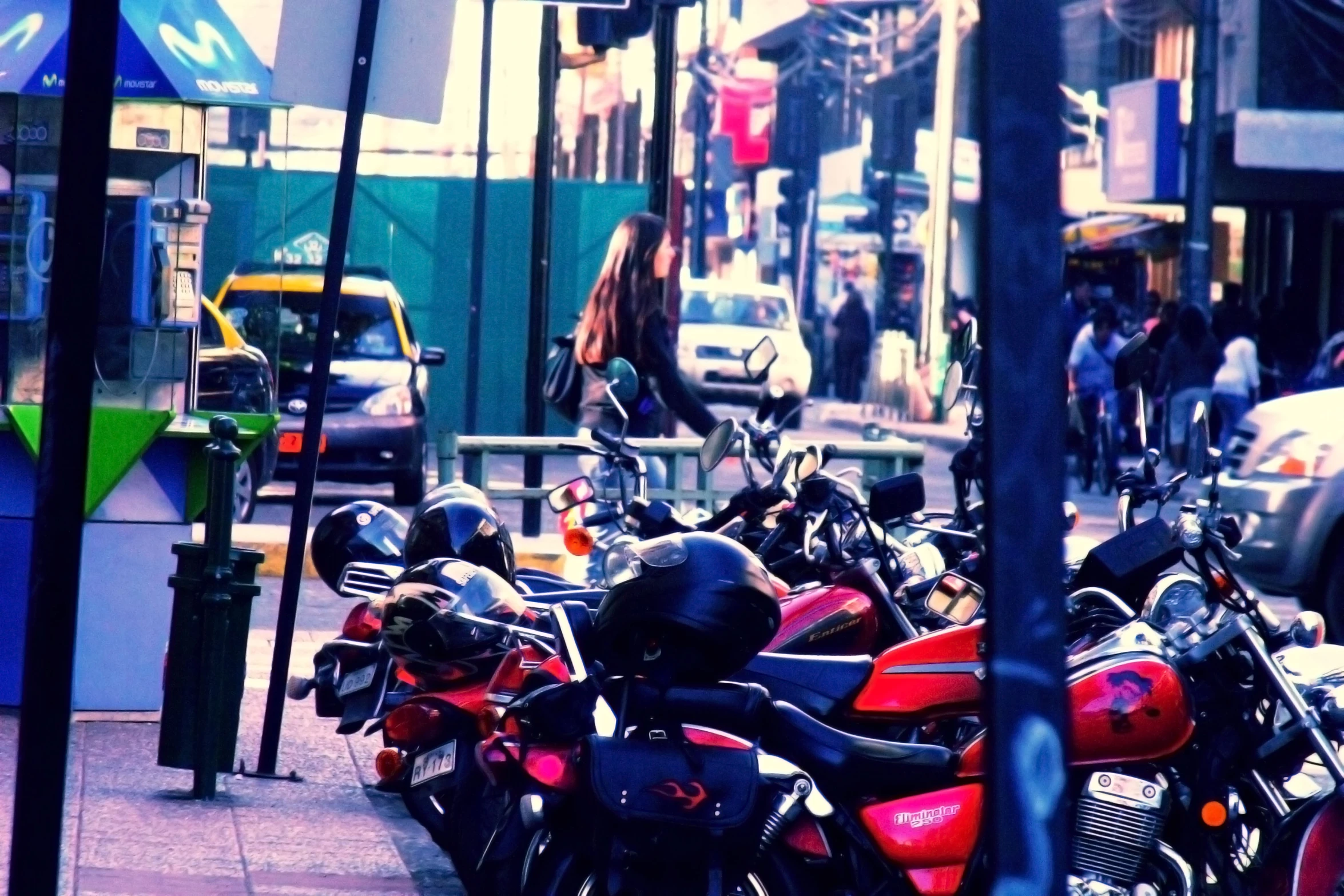 lots of motorcycles are parked next to each other on the side of the street