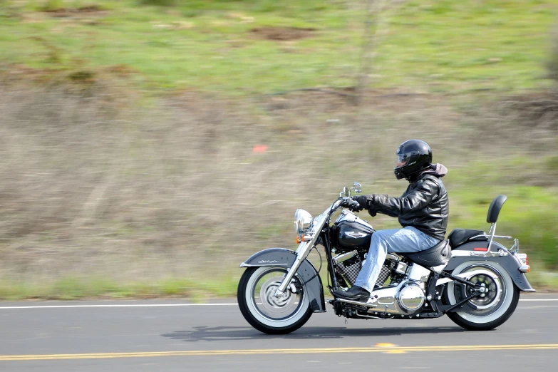 there is a person riding on the road on a motorcycle