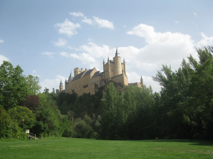 a very tall castle sitting on top of a lush green field