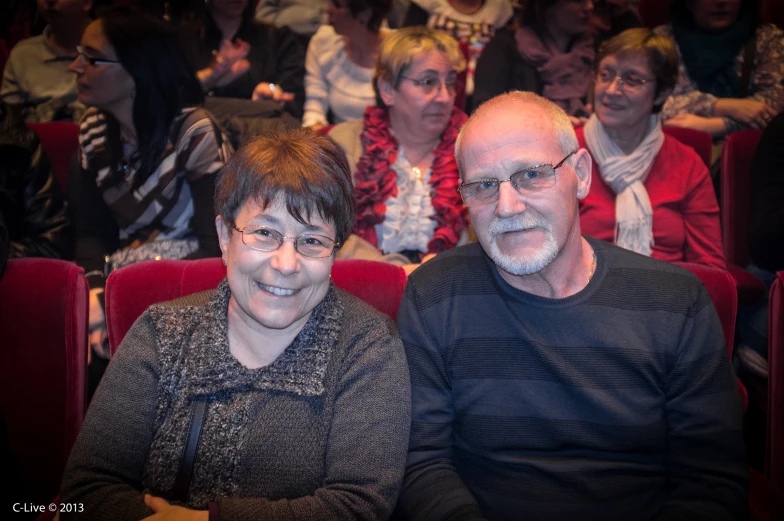 two people are sitting on seats and smiling for a po