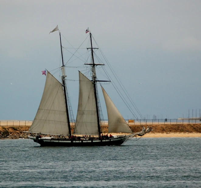 a sailing ship in the open water on a clear day