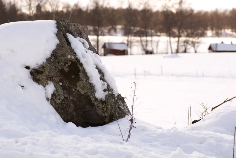 a large rock that is partially covered in snow