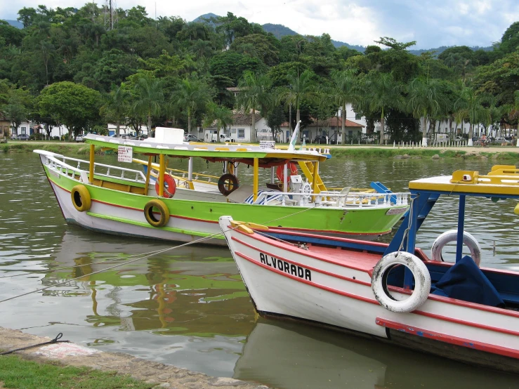 two boats that are sitting on some water