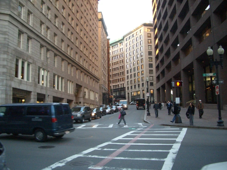 some buildings and some people walking around the street