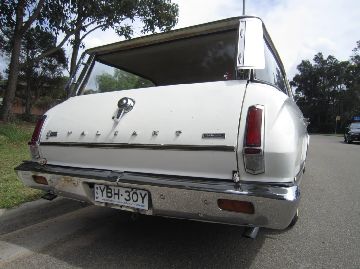 a truck with its doors open is parked by the curb