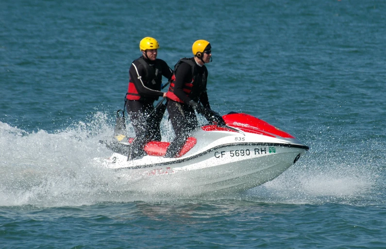 two people are riding a jet ski on the water