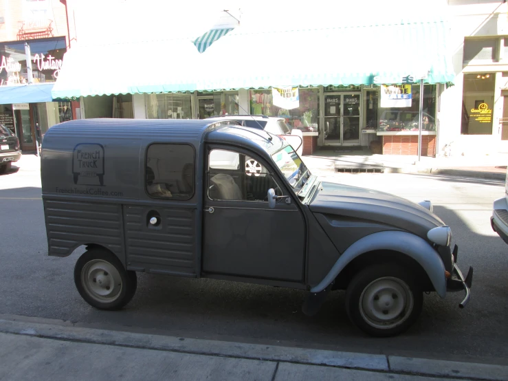 an old, very cute looking truck on the side of the street