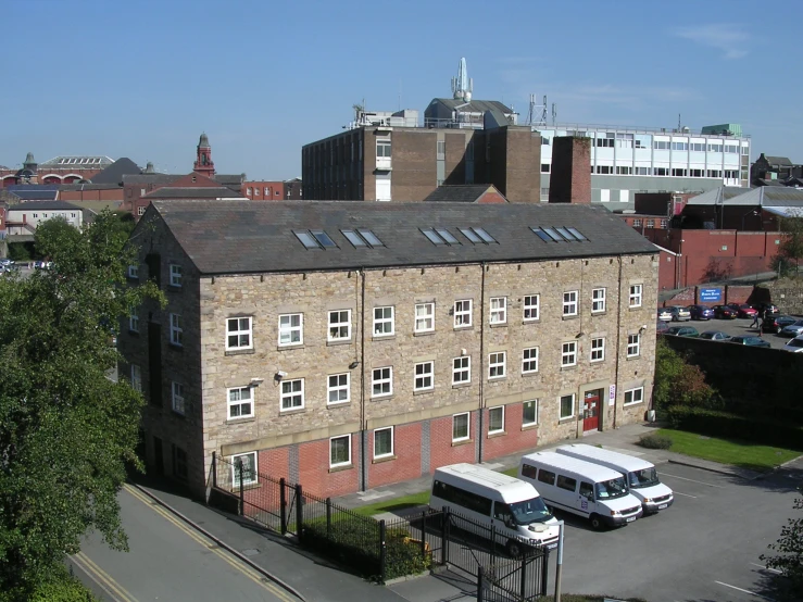 a truck and a bus outside a brick building