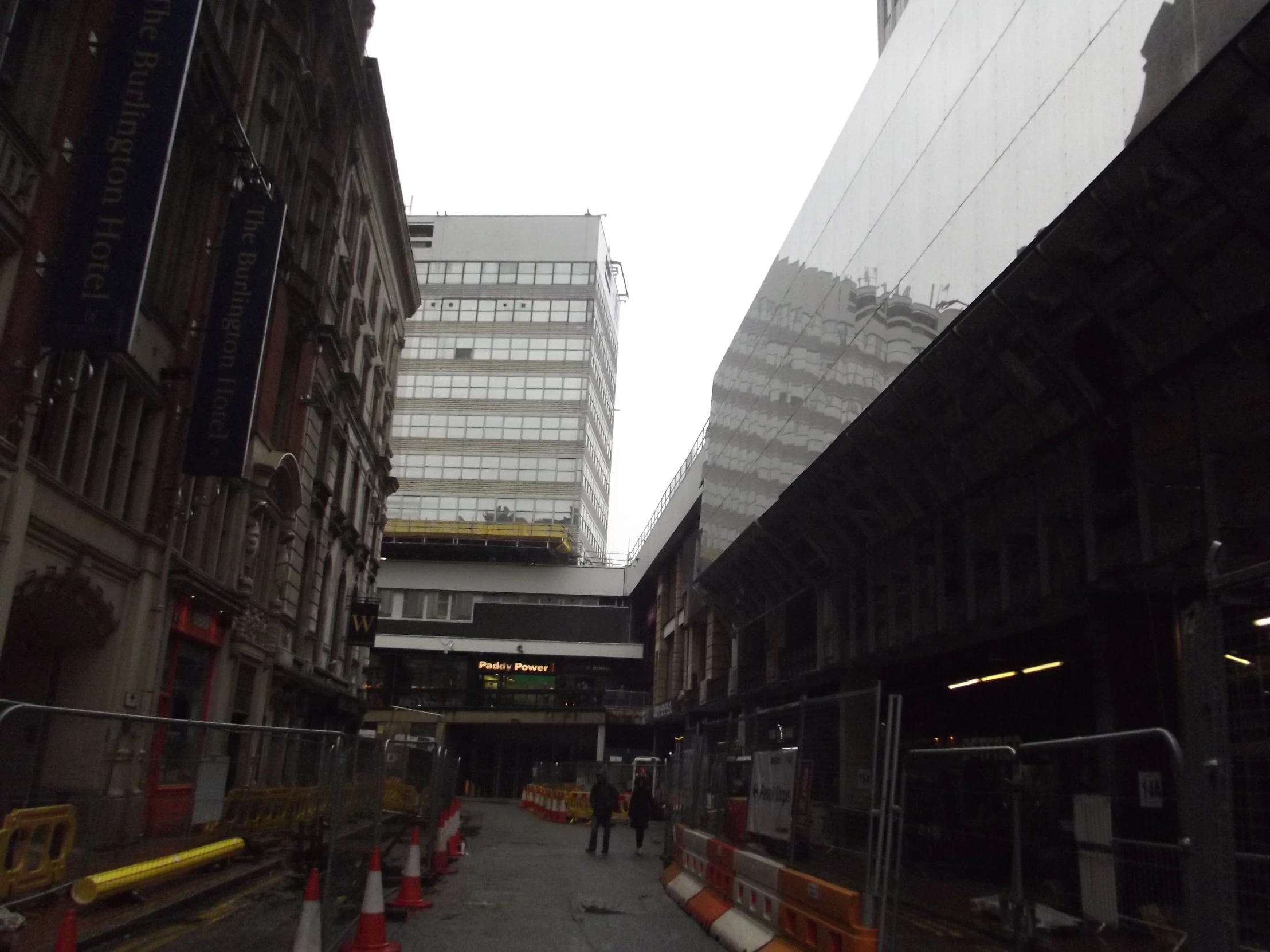 a wet city street with cars on it