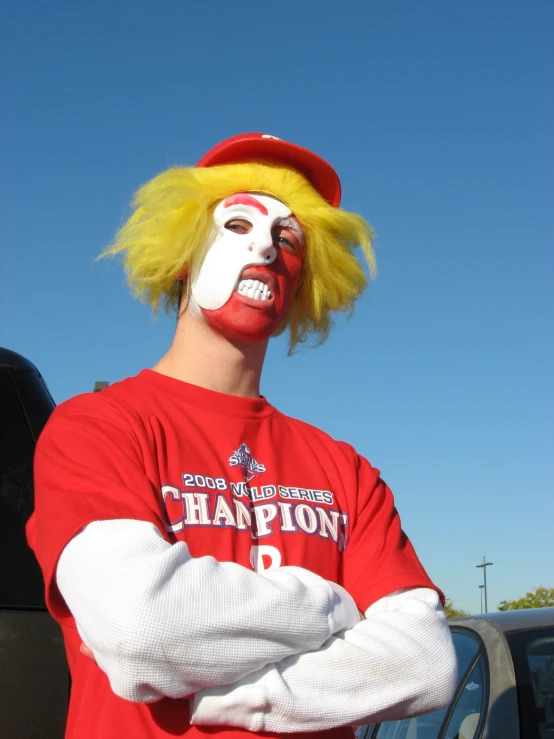 a man wearing a face paint and wig